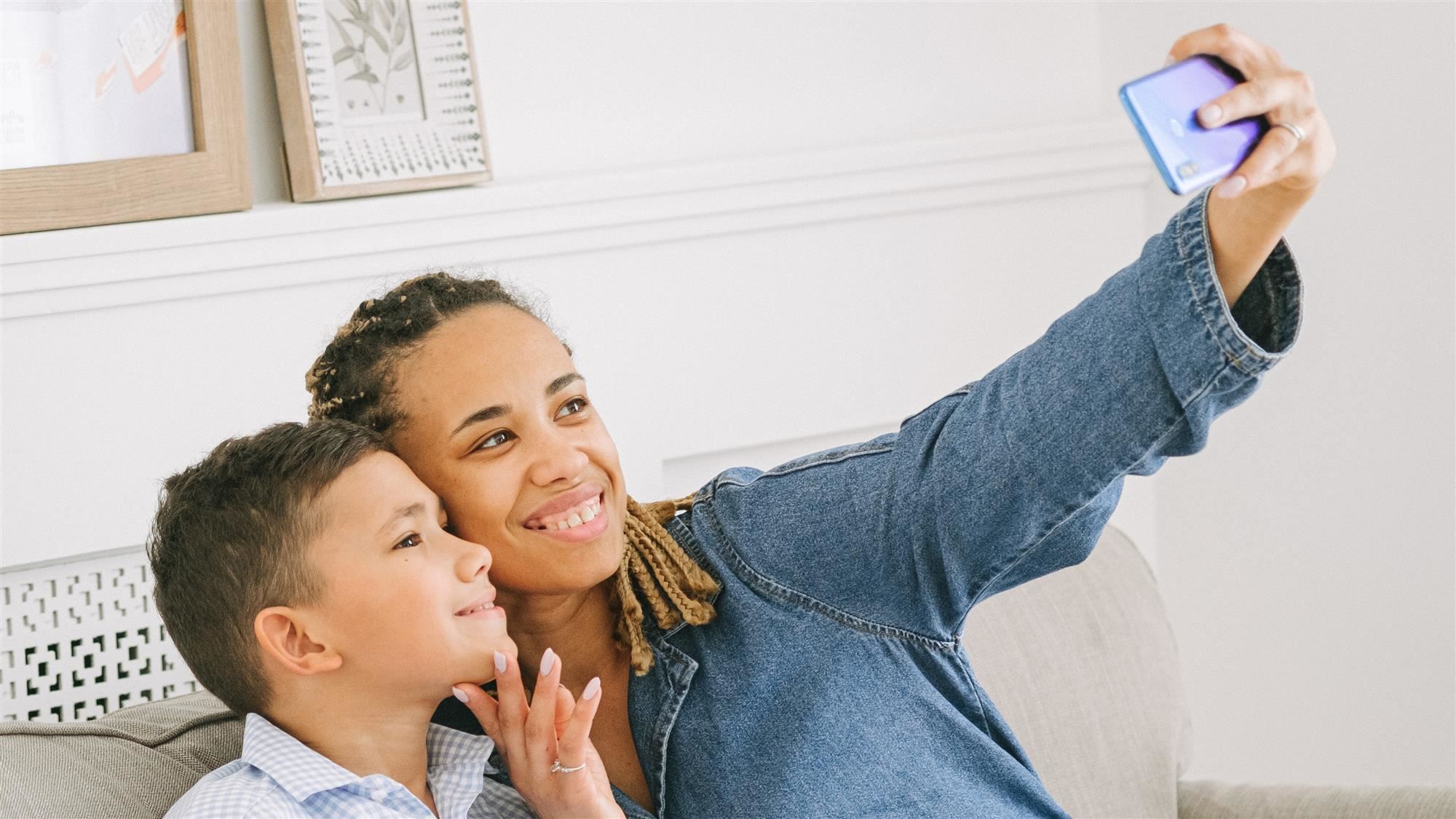 Mom taking a selfie photo with son